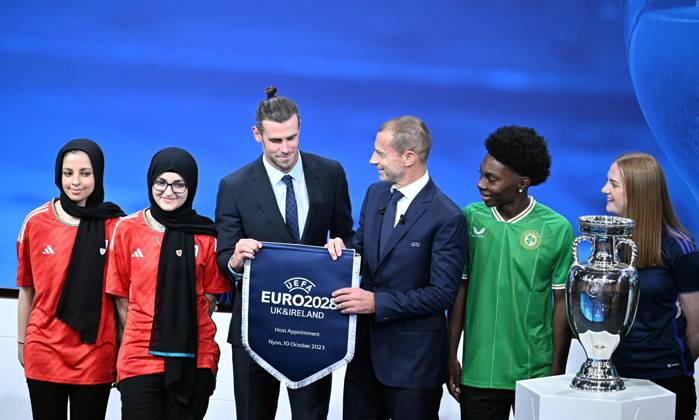 Ireland and United Kingdom confirmed to co-host 2028 UEFA European Football Championship GENEVA, SWITZERLAND - OCTOBER 10: UEFA President Aleksander Ceferin (3rd R) and Welsh retired professional footballer, heading the delegation of UK and Ireland Gareth Bale (3rd L) hold the pennant as they pose with the pennant next to the trophy after United Kingdom and Ireland were elected to host the Euro 2028 football tournament during a ceremony held after the Executive Board meeting at the UEFA headquarters in Nyon, Geneva, Switzerland on October 10, 2023. Geneve Isviçre. Editorial use only. Please get in touch for any other usage. Copyright: x2025xAnadoluxDursunxAydemirx