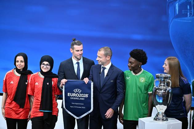 Ireland and United Kingdom confirmed to co-host 2028 UEFA European Football Championship GENEVA, SWITZERLAND - OCTOBER 10: UEFA President Aleksander Ceferin (3rd R) and Welsh retired professional footballer, heading the delegation of UK and Ireland Gareth Bale (3rd L) hold the pennant as they pose with the pennant next to the trophy after United Kingdom and Ireland were elected to host the Euro 2028 football tournament during a ceremony held after the Executive Board meeting at the UEFA headquarters in Nyon, Geneva, Switzerland on October 10, 2023. Geneve Isviçre. Editorial use only. Please get in touch for any other usage. Copyright: x2025xAnadoluxDursunxAydemirx