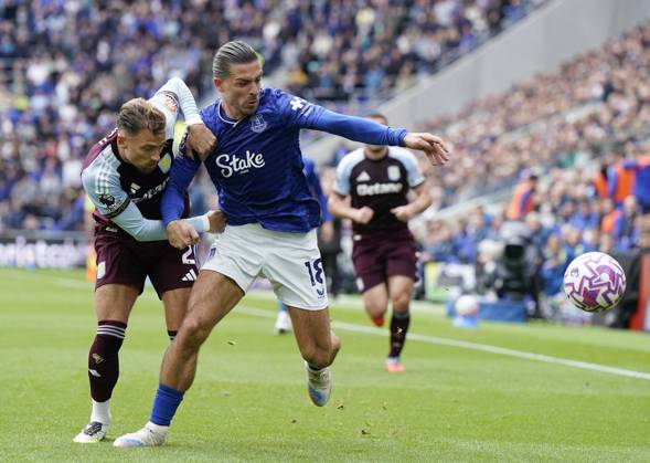 Liverpool, England, 13th September 2025. Jack Grealish of Everton (R) is challenged by Matty Cash of Aston Villa during the Everton vs Aston Villa Premier League match at Hill Dickinson Stadium, Liverpool. Picture credit should read: Andrew Yates Sportimage EDITORIAL USE ONLY. No use with unauthorised audio, video, data, fixture lists, club league logos or live services. Online in-match use limited to 120 images, no video emulation. No use in betting, games or single club league player publications. SPI_009_AY_EVERTON_VILLA SPI-4134-0008