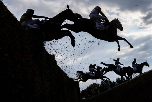 From left jockeys Jakub Kocman on Cuwall horse, Jan Kratochvil of Chlemsdorf horse and back left is Michael Donoghue on Stumptown horse crossing the Taxis ditch in 135th edition of the Grand Pardubice Steeplechase on October 12, 2025, Pardubice, Czech Republic. (CTKxPhoto RomanxVondrous) CTKPhotoP2025101204340  CTKPhotoP2025101204340
