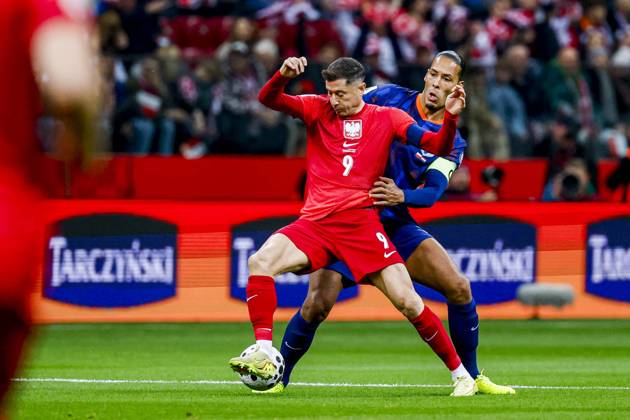 Robert Lewandowski of Poland and Virgil van Dijk of the Netherlands battle for the ball Poland v Netherlands, FIFA World Cup, WM, Weltmeisterschaft, Fussball 2026 Qualifier, Poland v Netherlands, PGE Narodowy, November 14, 2025, Warsaw, Poland.