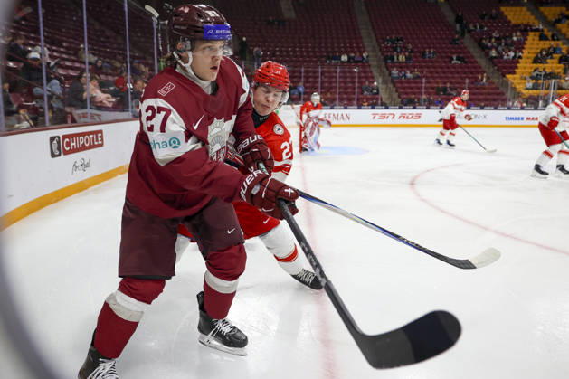 December 30, 2025, Minneapolis, Minnesota, United States: Latvia forward MARKUSS SIERADZKIS (27) and Denmark forward LASSE BAERENTSEN (23) connect in the corner. Latvia and Denmark faced off in the opening round of the IIHF World Junior Championship on December 30th. Latvia was victorious winning 6-3. Minneapolis United States - ZUMAt166 20251230_zsp_t166_021 Copyright: xMichaelxTurnerx
