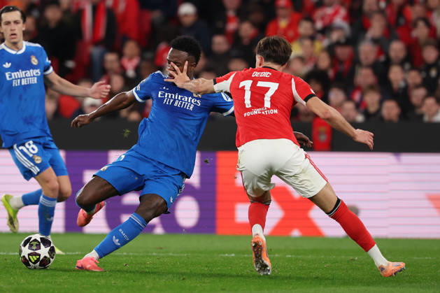 FBL-UEFA Champions League 2025-26 SL Benfica - Real Madrid Vinicius Junior (Real Madrid) in action, with the ball, Amar Dedic (S.L.Benfica) during UEFA Champions League 2025-26 KO play-offs match between Lisboa e Benfica and Real Madrid at Estadio da Luz on Thursday 17 February 2026 in Lisbon, Portugal Copyright: JoaquimxFerreira