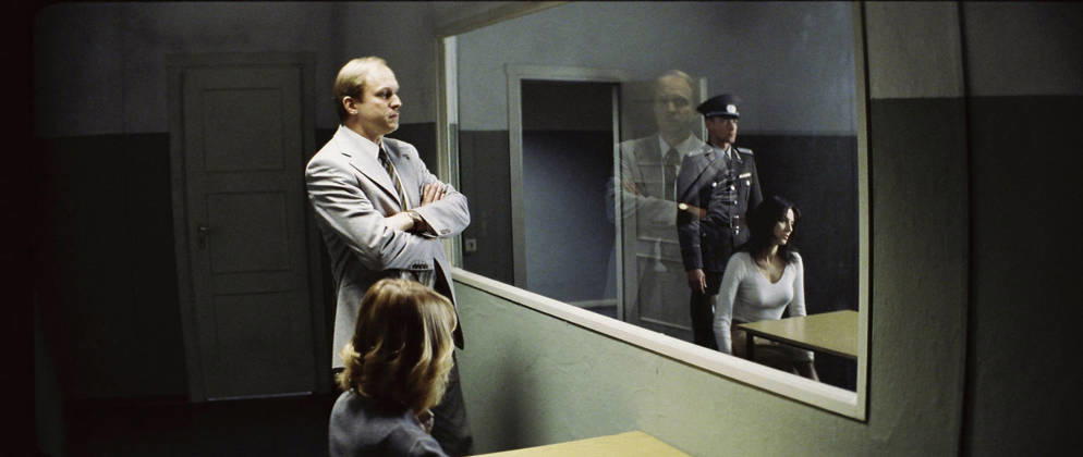 RELEASE DATE: February 9, 2007. MOVIE TITLE: Das Leben der Anderen (North America: The Lives of Others ) - STUDIO: Creado Film Sony Pictures Classics. PLOT: Captain Wiesler (Muhe) is a wiretapping expert with the Stasi (East German Secret Police) in the mid-eighties,who becomes disillusioned with his career and life in general in the former socialist republic when his latest assignment, Georg Dreyman (Koch), a playwright with views against the totalitarian state, starts to challenge his beliefs through his overheard conversations. PICTURED: ULRICH TUKUR (center-left) as Oberstleutnant Anton Grubitz, and MARTINA GEDECK (center-right) as Christa-Maria Sieland. Hollywood California USA Copyright: xRepublicxPicturesx