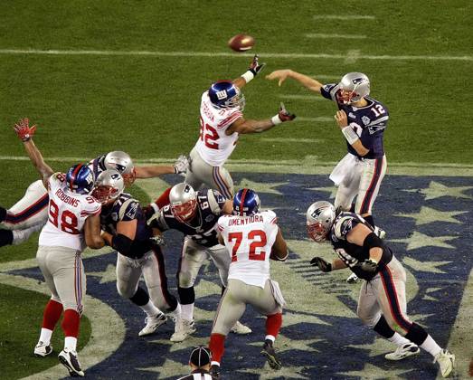 Feb. 3, 2008 - New England Patriots quarterback Tom Brady makes a pass over the pressure of the New York Giants Michael Strahan (92) in the third qurter of Super Bowl XLII at University of Phoenix Stadium in Glendale, Arizona, on Sunday, February 3, 2008. (Mark Cornelison MCT) Copyright: xMarkxCornelisonx