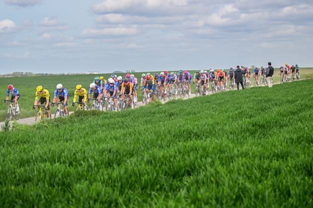 The pack of riders pictured in action during the men s Paris-Roubaix cycling race, Sunday 12 April 2026, around Roubaix, France. The 123rd edition of Paris-Roubaix cycling races will take on Sunday, with the women riding 143,1 km the men riding 258,3 km on Sunday. DIRKxWAEM x170553200x
