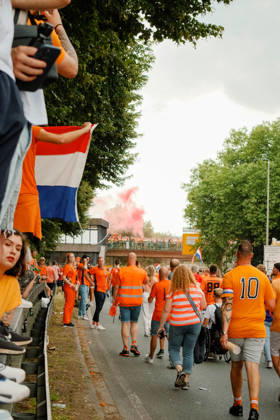 10.07.24, Football, UEFA EURO, EM, Europameisterschaft,Fussball 2024, Netherlands Fan March Netherlands fans stand along the road as red smoke rises from a bridge in the distance during the Dutch fan march in Dortmund, Germany, before the UEFA Euro 2024 semi-final against England. Dortmund Dortmund NRW Germany