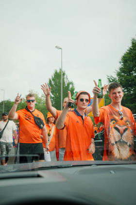 10.07.24, Football, UEFA EURO, EM, Europameisterschaft,Fussball 2024, Netherlands Fan March Netherlands supporters in orange shirts pose and gesture toward the camera with drinks in hand during the Dutch fan march in Dortmund, Germany, before the UEFA Euro 2024 semi-final against England. Dortmund Dortmund NRW Germany