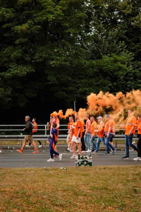 10.07.24, Football, UEFA EURO, EM, Europameisterschaft,Fussball 2024, Netherlands Fan March Netherlands supporters in orange shirts walk along the road as orange smoke rises above the fan march in Dortmund, Germany, ahead of the UEFA Euro 2024 semi-final match between the Netherlands and England. Dortmund Dortmund NRW Germany