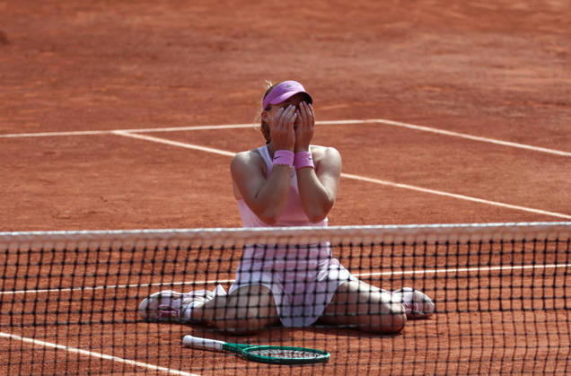 Russian Mirra Andreeva collapses onto the clay after winning her final s match against Polish Maja Chwalinska at the French Tennis Open in Roland Garros in Paris, France, on Saturday, June 6, 2026. Andreeva won 6-3, 6-2.  PAR20260606103 MayaxVIDON-WHITE