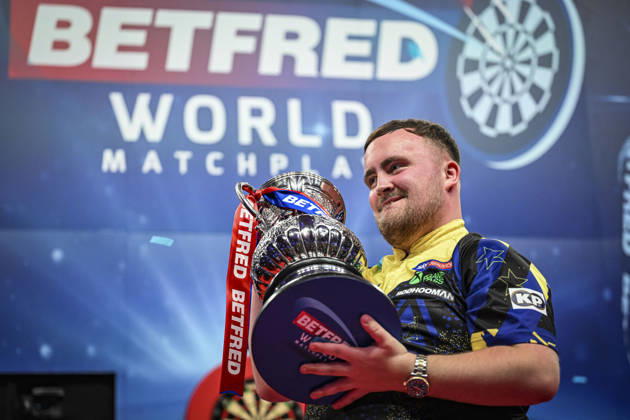 RECORD DATE NOT STATED 26th July 2026, Winter Gardens, Blackpool, Lancashire, England; 2026 Betfred World Matchplay Darts, Mens, Final Day; Luke Littler celebrates winning his final match against Gerwyn Price and holds the Betfred World Matchplay trophy GodfreyxPitt