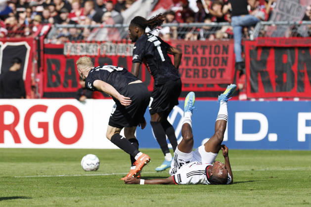 KOELN, GERMANY - AUGUST 22, 2026: Mohamed Alì Zoma (1. FC Nuernberg, 23) tackled by Meiko Sponsel (Viktoria Koeln, 19) and Yannick Tonye (Viktoria Koeln, 7) during the DFB-Cup match between Viktoria Koeln vs. 1. FC Nuernberg at the Sportpark Hoehenberg on August 22, 2026 in Koeln, Germany. DFL REGULATIONS PROHIBIT ANY USE OF PHOTOGRAPHS AS IMAGE SEQUENCES AND OR QUASI-VIDEO. Nordrhein-Westfalen Germany Copyright: xAxelxKohringx