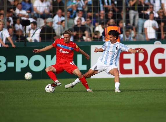 Fussball, Herren, DFB-Pokal, 1.Hauptrunde, Saison 2026 2027, TSV 1860 München - Holstein Kiel, Grünwalder Stadion Jonas Therkelsen (Holstein Kiel) (li.) mit Tunay Deniz (TSV 1860 München) (re.) im Zweikampf um den Ball