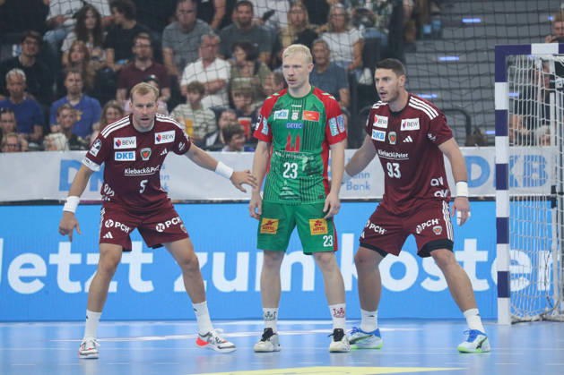 22.08.2026, xgox, Handball, Rexel Supercup 2026, SC Magdeburg - Füchse Berlin, v.l. Max Darj (Berlin, 5), Magnus Saugstrup (Magdeburg, 23), Mijajlo Marsenic (Berlin, 93) Zweikampf, Duell, Kampf, tackle München