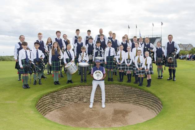 BALMEDIE, SCOTLAND - AUG 23: Scott Jamieson (SCO) holds the Nexo Trophy with the Robert Gordon Academy Pipe band after Round 4 at the 2026 Nexo Championship at the Trump International Golf Links, Balmedie on August 23, 2026 in Aberdeenshire, Scotland The 2026 Nexo Championship