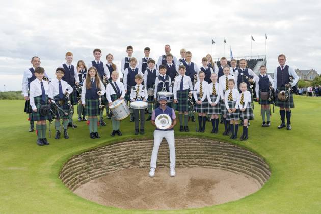 BALMEDIE, SCOTLAND - AUG 23: Scott Jamieson (SCO) holds the Nexo Trophy with the Robert Gordon Academy Pipe band after Round 4 at the 2026 Nexo Championship at the Trump International Golf Links, Balmedie on August 23, 2026 in Aberdeenshire, Scotland The 2026 Nexo Championship
