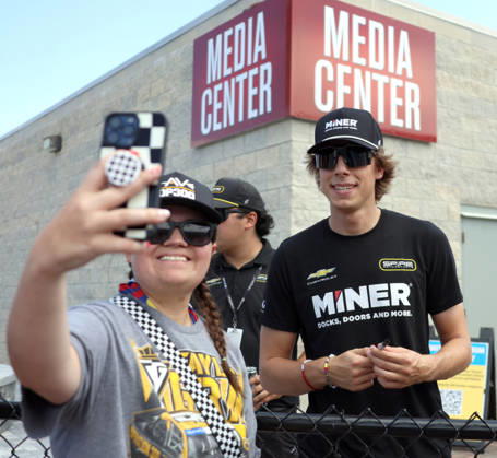 DAYTONA BEACH, FL - AUGUST 28: Carson Hocevar ( 77 Spire Motorsports Miner Docks, Doors and More Chevrolet) takes a selfie with a fan before qualifying for the NASCAR, Motorsport, USA Cup Series Coke Zero Sugar 400 on August 28, 2026 at Daytona International Speedway in Daytona Beach, FL. (Photo by Michael Bush Icon Sportswire) AUTO: AUG 28 NASCAR Cup Series Coke Zero Sugar 400 EDITORIAL USE ONLY Icon260828012