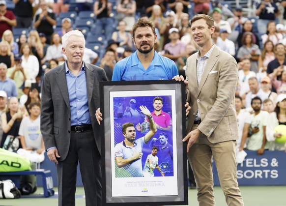 US Open Tournament Director Eric Butorac and USTA CEO Craig Tiley present Stan Wawrinka of Switzerland with a gift after his first round match against Matteo Berrettini in The Grandstand at the 2026 US Open Tennis Championship at the USTA Billie Jean King National Tennis Center in New York City on Monday, August 31, 2026. Stan Wawrinka ended his Grand Slam career with his loss to Berrettini in straight sets.  NYP20260831113 JOHNxANGELILLO