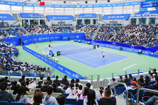 (261007) -- BEIJING, Oct. 7, 2026 -- People enjoy a match during the Jingshan Tennis Open in Jingshan, central China s Hubei Province, Oct. 4, 2026. (Photo by Xinhua) Xinhua Headlines: Small counties, big appeal: China s golden week fuels diverse getaways LeixYixin 