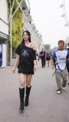 October 8, 2026, Singapore, Kaohsiung City, Singapore: LIAM LAWSON of Oracle Red Bull Racing approaches TZUYU (CHOU TZU-YU), Taiwanese member of K-pop girl group TWICE, to greet her during her visit to the Williams Racing paddock ahead of the 2026 Formula 1 Singapore Grand Prix at Marina Bay Street Circuit in Singapore. Singapore Singapore - ZUMAh201 20261008_zsp_h201_029 Copyright: xYichinxHoux