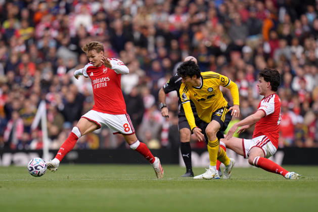 10th October 2026; Emirates Stadium, London, England; Premier League Football, Arsenal versus Leeds United; Martin Odegaard of Arsenal runs with the ball under pressure from Ao Tanaka TomxMajor