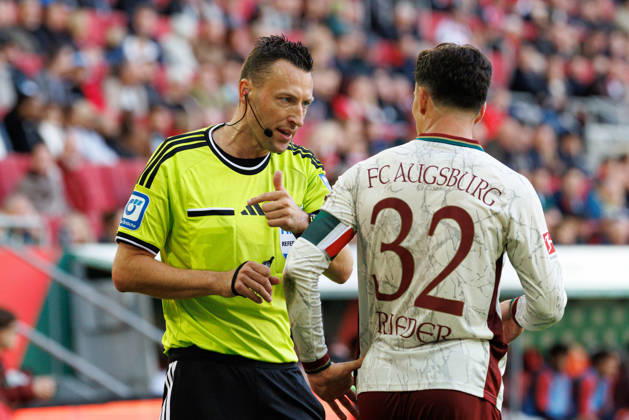 Sven Jablonski (Schiedsrichter:in) diskutiert mit Fabian Rieder (32, FC Augsburg) beim Spiel zwischen FC Augsburg v FC Bayern München, Fussball, Herren, Bundesliga, 2026 2027, 5.Spieltag am 10.10.2026 in Augsburg, WWK ARENA. DFL and DFB regulations prohibit any use of photographs as image sequences and or quasi-video. Bayern Deutschland