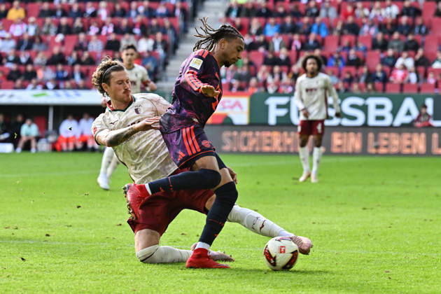 AUGSBURG, GERMANY; 10. OCTOBER: tackle between Michael OLISE (FC Bayern Munich 17) and Calvin BRACKELMANN (FC Augsburg 2) during the Bundesliga Match between FC Augsburg vs. FC Bayern Munich at Matchday 5 at WWK-Arena DFL REGULATIONS PROHIBIT ANY USE OF PHOTOGRAPHS AS IMAGE SEQUENCES AND OR QUASI-VIDEO Copyright: xBEAUTIFULxSPORTS Goldbergx