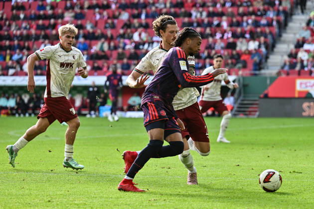 AUGSBURG, GERMANY; 10. OCTOBER: tackle between Michael OLISE (FC Bayern Munich 17) and Calvin BRACKELMANN (FC Augsburg 2) during the Bundesliga Match between FC Augsburg vs. FC Bayern Munich at Matchday 5 at WWK-Arena DFL REGULATIONS PROHIBIT ANY USE OF PHOTOGRAPHS AS IMAGE SEQUENCES AND OR QUASI-VIDEO Copyright: xBEAUTIFULxSPORTS Goldbergx
