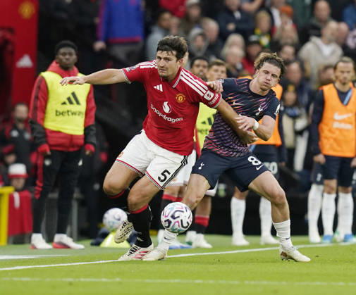 Manchester, England, 10th October 2026. Harry Maguire of Manchester United, ManU held by Conor Gallagher of Tottenham during the Manchester United vs Tottenham Hotspur Premier League match at Old Trafford, Manchester. Picture credit should read: Andrew Yates Sportimage EDITORIAL USE ONLY. No use with unauthorised audio, video, data, fixture lists, club league logos or live services. Online in-match use limited to 120 images, no video emulation. No use in betting, games or single club league player publications. SPI_040_AY_MANUTD_SPURS SPI-5058-0040