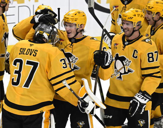 Pittsburgh Penguins defenseman Kaedan Korczak (6) and Pittsburgh Penguins center Sidney Crosby (87) celebrates the overtime shootout victory with Pittsburgh Penguins goaltender Arturs Silovs (37) following the 2-1 win at PPG Paints Arena in Pittsburgh on Saturday, October, 10 2026.  PIT2026101013 ARCHIExCARPENTER