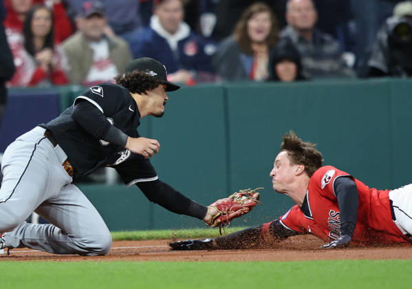 Cleveland Guardians Petey Halpin (0) is tagged out at third by Chicago White Sox third baseman Miguel Vargas (20) after trying to stretch a double into a triple in the fifth inning of an MLB, Baseball Herren, USA American League Division Series at Progressive Field in Cleveland, Ohio, on Saturday, October 10, 2026.  CLE20261010790 AARONxJOSEFCZYK