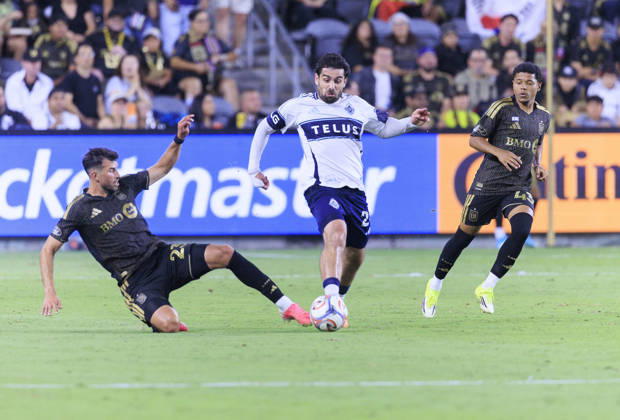 October 10, 2026, Los Angeles, California, USA: Yevhen Cheberko 24 of the Los Angeles Football Club slide tackles Brian White 24 of the Vancouver Whitecaps during their regular season MLS, Fussball Herren, USA game on Saturday October 10, 2026 at the BMO Stadium in Los Angeles, California. LAFC tie with Whitecaps, 1-1. ARIANA RUIZ PI Los Angeles USA - ZUMAp124 20261010_zaa_p124_022 Copyright: xArianaxRuizx