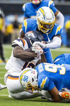 October 11, 2026, Inglewood, California, USA: Denver Broncos Wide Receiver Marvin Mims Jr. (19) is brought down by Los Angeles Chargers defensive lineman Nick Barrett (91) and safety RJ Mickens (27) during an NFL, American Football Herren, USA football game, in Inglewood, Calif. on Sunday Oct. 11, 2026. Inglewood USA - ZUMAc68_ 20261011_zaf_c68_007 Copyright: xRingoxChiux