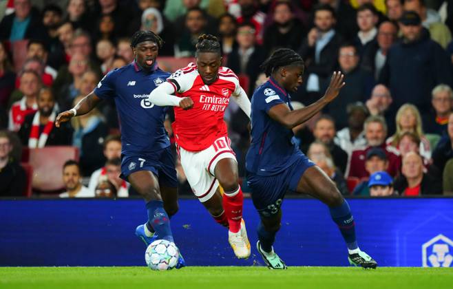 Eberechi Eze of Arsenal finds a gap b etween Dilane Bakwa and Maxima Goffi of Lille Arsenal v Lille, UEFA Champions League, Football, Emirates Stadium, London, UK - 13 Oct 2026London Emirates Stadium United Kingdom  Copyright: xJavierxGarcia Shutterstockx 17213973s