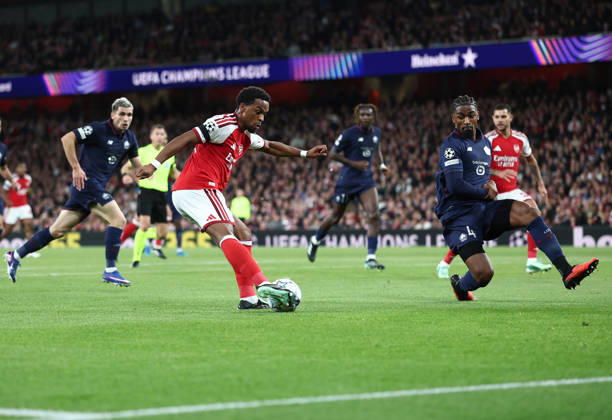 London, England, 13th October 2026. Jurrien Timber of Arsenal gets in a shot on goal as Alexsandro of LOSC Lille closes induring the Arsenal vs LOSC Lille UEFA Champions League match at the Emirates Stadium, London. Picture credit should read: David Klein Sportimage EDITORIAL USE ONLY. No use with unauthorised audio, video, data, fixture lists, club league logos or live services. Online in-match use limited to 120 images, no video emulation. No use in betting, games or single club league player publications. SPI_028_DK_Arsenal_Lille SPI-5065-0029