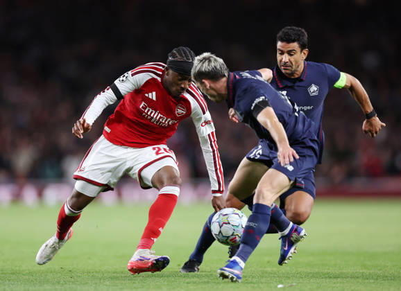 London, England, 13th October 2026. Noni Madueke of Arsenal takes on Benjamin Andre of LOSC Lille (r)during the Arsenal vs LOSC Lille UEFA Champions League match at the Emirates Stadium, London. Picture credit should read: David Klein Sportimage EDITORIAL USE ONLY. No use with unauthorised audio, video, data, fixture lists, club league logos or live services. Online in-match use limited to 120 images, no video emulation. No use in betting, games or single club league player publications. SPI_029_DK_Arsenal_Lille SPI-5065-0030