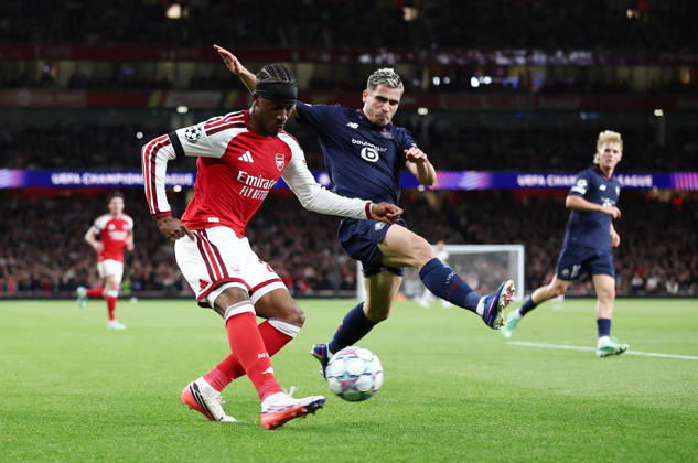 London, England, 13th October 2026. Noni Madueke of Arsenal and Romain Perraud of LOSC Lille during the Arsenal vs LOSC Lille UEFA Champions League match at the Emirates Stadium, London. Picture credit should read: David Klein Sportimage EDITORIAL USE ONLY. No use with unauthorised audio, video, data, fixture lists, club league logos or live services. Online in-match use limited to 120 images, no video emulation. No use in betting, games or single club league player publications. SPI_032_DK_Arsenal_Lille SPI-5065-0033