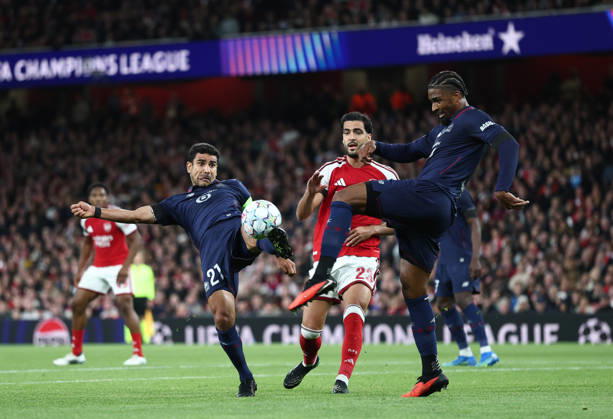 London, England, 13th October 2026. Benjamin Andre of LOSC Lille (l) and Alexsandro of LOSC Lille (r) clear the ball under pressure from Mikel Merino of Arsenal (c) during the Arsenal vs LOSC Lille UEFA Champions League match at the Emirates Stadium, London. Picture credit should read: David Klein Sportimage EDITORIAL USE ONLY. No use with unauthorised audio, video, data, fixture lists, club league logos or live services. Online in-match use limited to 120 images, no video emulation. No use in betting, games or single club league player publications. SPI_035_DK_Arsenal_Lille SPI-5065-0036