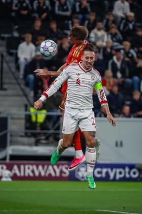 SOCCER - UEFA CL, LASK vs Liverpool LINZ,AUSTRIA,14.OCT.26 - SOCCER - UEFA Champions League, Linzer ASK vs Liverpool FC. Image shows Krystof Danek (LASK) and Kostas Tsimikas (Liverpool).  GEPAxpictures xManuelxBinder