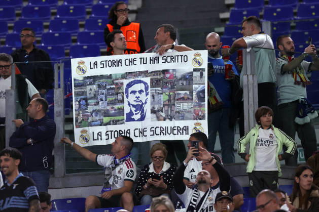 SOCCER - UEFA Champions League - AS Roma vs. Real Madrid Photo by IPA ABACAPRESS.COM89686137 - Rome, Italy — October 14, 2026: A Real Madrid fan in the stands holding a Mourinho banner and Lazio flags during the 2026–2027 UEFA Champions League soccer match between AS Roma and Real Madrid CF at the Olympic Stadium in Rome. Rome Italy Copyright: xIPAxSport ABACAx