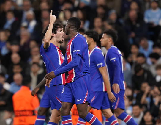 Manchester, England, 14th October 2026. Vitinha of Paris Saint-Germain (l) lcelebrates scoring their third goal during the Manchester City vs Paris Saint Germain UEFA Champions League match at the Etihad Stadium, Manchester. Picture credit should read: Andrew Yates Sportimage EDITORIAL USE ONLY. No use with unauthorised audio, video, data, fixture lists, club league logos or live services. Online in-match use limited to 120 images, no video emulation. No use in betting, games or single club league player publications. SPI_032_AY_Man_City_PSG SPI-5069-0032