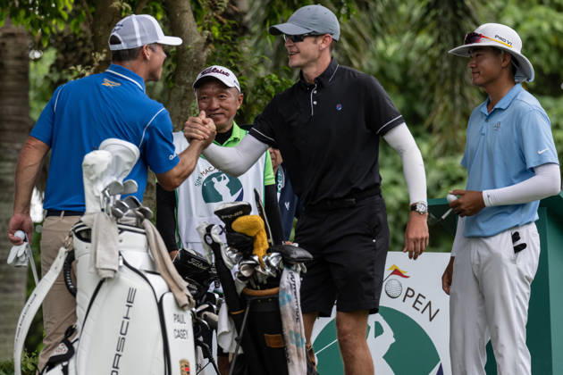 October 18, 2026, Macau, Macao Sar, China: Paul CASEY from England greets USAÃ¢â‚¬â ¢s Andy OGLETREEÃ¢â‚¬â ¢s Caddy (R) Macau Open Golf 2026 Final Round. Macau Open Golf 2026 Final Round  - ZUMAr144 20261018_zap_r144_007 Copyright: xJaynexRussellx