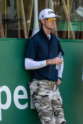 October 18, 2026, Macau, Macao Sar, China: Charles PORTER from the USA takes the tied lead on -14 Par with a stunning -9 Par final round. PORTER and his caddy hide from the heat in the shade of the hospitality stand on the 18th green. Macau Open Golf 2026 Final Round. Macau Open Golf 2026 Final Round  - ZUMAr144 20261018_zap_r144_044 Copyright: xJaynexRussellx