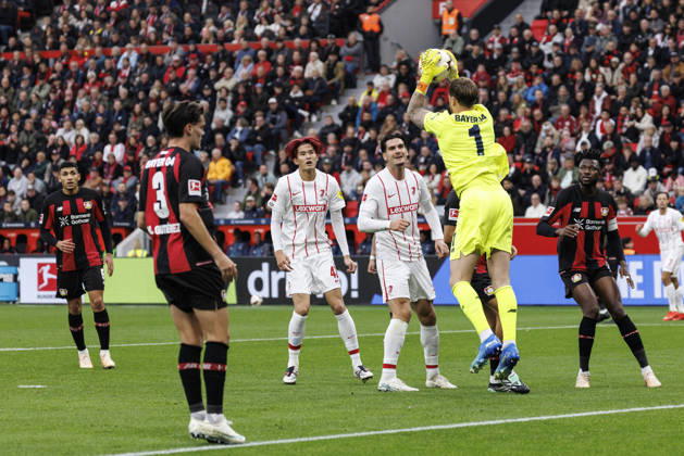 LEVERKUSEN, GERMANY - OCTOBER 18, 2026: Mark Flekken (Bayer 04 Leverkusen, 1) saves the ball before Keisuke Goto (SC Freiburg, 42) and Igor Matanovic (SC Freiburg, 31) during the German Bundesliga match on gameday 6 between Bayer 04 Leverkusen vs. SC Freiburg at BayArena on October 18, 2026 in Leverkusen, Germany. DFL REGULATIONS PROHIBIT ANY USE OF PHOTOGRAPHS AS IMAGE SEQUENCES AND OR QUASI-VIDEO. Northrhine-Westphalia Germany Copyright: xAxelxKohringx
