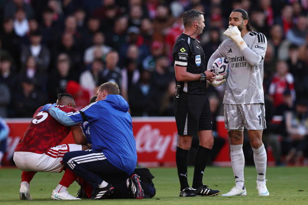 Nottingham, England, 18th October 2026. Murillo of Nottingham Forest receives medical treatment while David Raya of Arsenal talks with referee Michael Oliver during the Nottingham Forest vs Arsenal Premier League match at the City Ground, Nottingham. Picture credit should read: Jake Youle Sportimage EDITORIAL USE ONLY. No use with unauthorised audio, video, data, fixture lists, club league logos or live services. Online in-match use limited to 120 images, no video emulation. No use in betting, games or single club league player publications. SPI_025_JY_Forest_Arsenal SPI-5083-0025