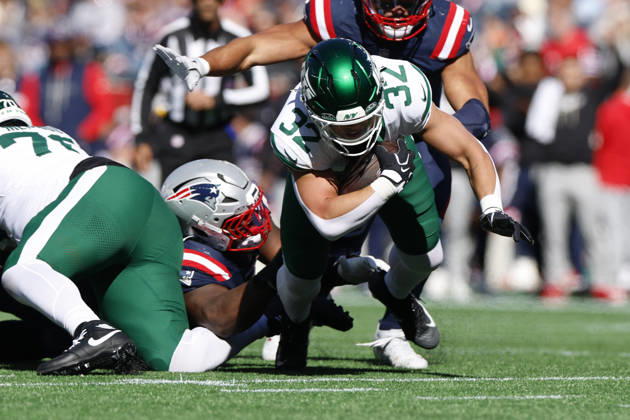 New York Jets running back Isaiah Davis, right, is taken down by New England Patriots guard Ben Brown during the first half at Gillette Stadium in Foxborough, Massachusetts on Sunday, October 18, 2026.  BOP20261018002 CJxGUNTHER