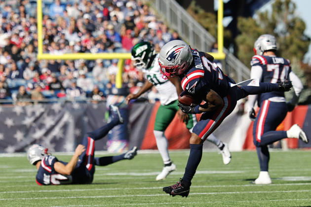 New England Patriots wide receiver DeMario Douglas, right, makes a catch as New England Patriots quarterback Drake Maye, left, is knocked down by New York Jets linebacker David Bailey, center, during the first half at Gillette Stadium in Foxborough, Massachusetts on Sunday, October 18, 2026.  BOP20261018008 CJxGUNTHER
