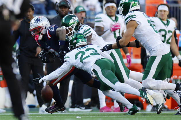 New England Patriots wide receiver DeMario Douglas, left, fumbles the ball during the second half against the New York Jets at Gillette Stadium in Foxborough, Massachusetts on Sunday, October 18, 2026.  BOP20261018015 CJxGUNTHER