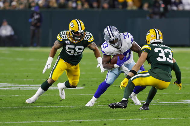 GREEN BAY, WI - OCTOBER 18: Dallas Cowboys running back Javonte Williams (33) tries to escape the tackle of Green Bay Packers safety Evan Williams (33) and Green Bay Packers linebacker Isaiah McDuffie (58) during a game between the Green Bay Packers and the Dallas Cowboys on October 18, 2026 at Lambeau Field in Green Bay, WI. (Photo by Larry Radloff Icon Sportswire) NFL, American Football Herren, USA OCT 18 Cowboys at Packers EDITORIAL USE ONLY Icon2610181009