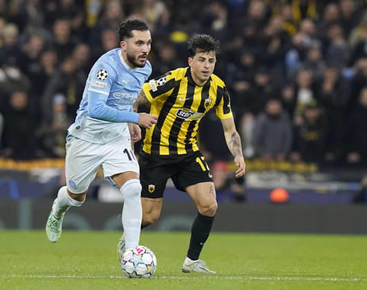 Manchester, England, 20th October 2026. Rayan Cherki of Manchester City and Lazaros Rota of AEK Athens during the Manchester City vs AEK Athens UEFA Champions League match at the Etihad Stadium, Manchester. Picture credit should read: Andrew Yates Sportimage EDITORIAL USE ONLY. No use with unauthorised audio, video, data, fixture lists, club league logos or live services. Online in-match use limited to 120 images, no video emulation. No use in betting, games or single club league player publications. SPI_025_AY_ManCity__Athens SPI-5090-0025